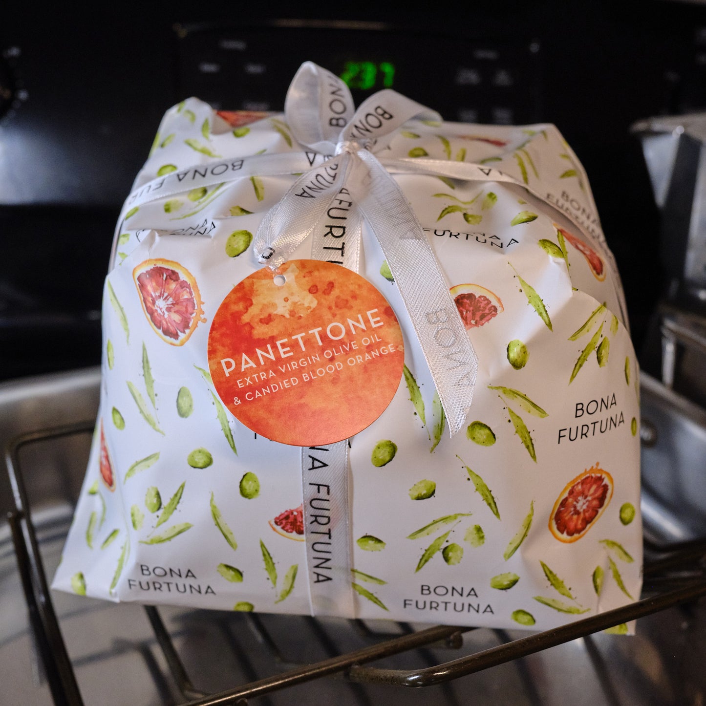 Panettone package with Bona Furtuna branding on a metal rack.