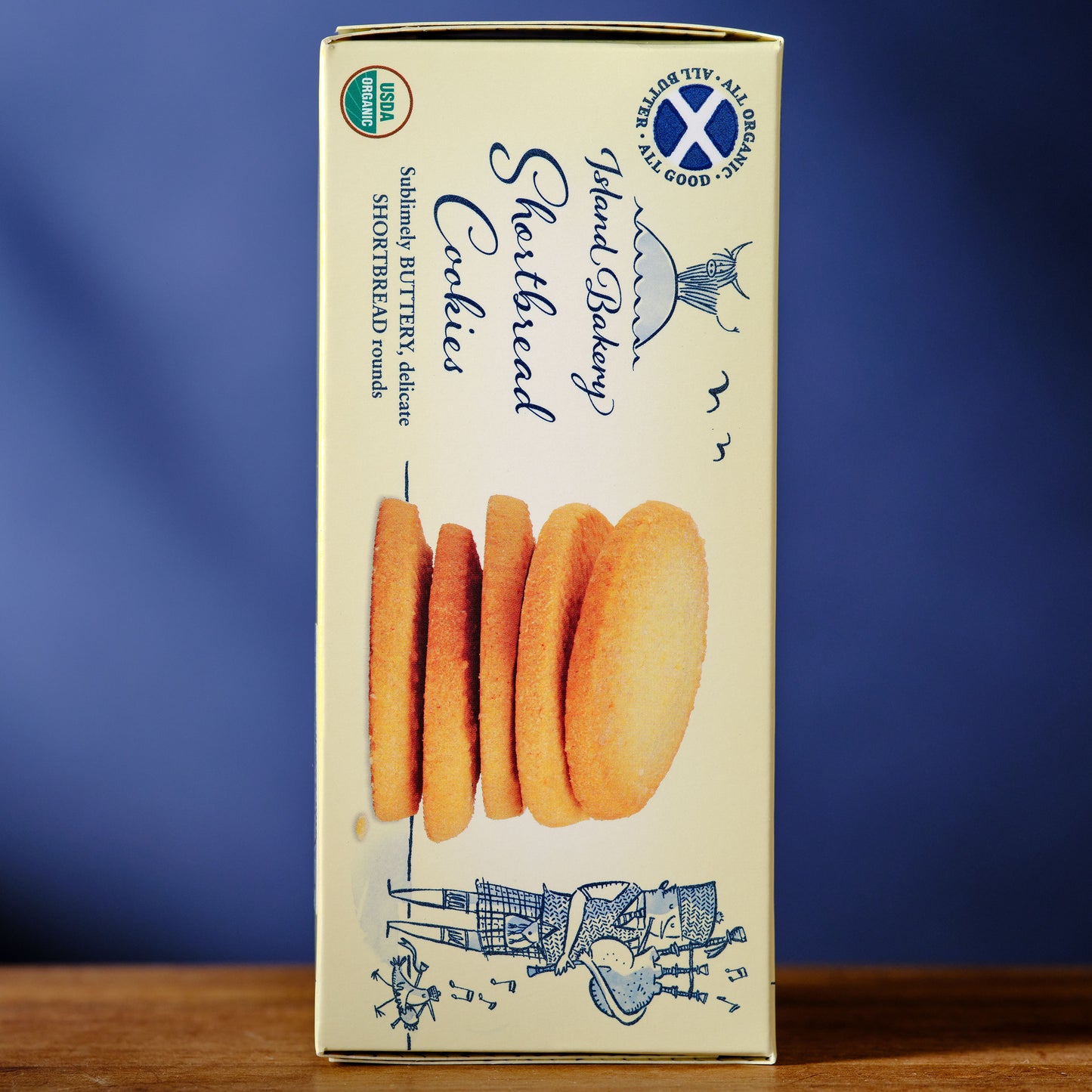 Box of Island Bakery Shortbread Cookies on a wooden surface with a blue background Island Bakery Shortbread Biscuits