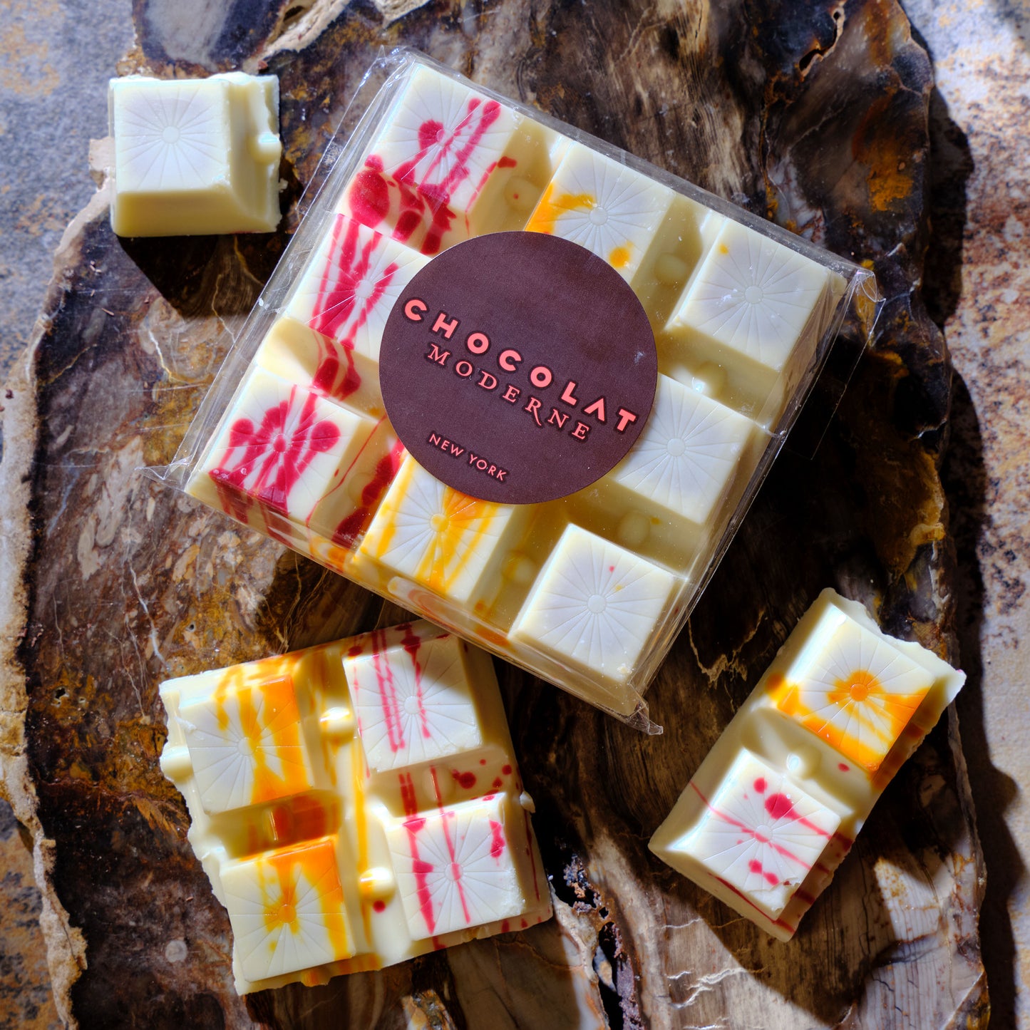 Packaged chocolates with visible brand 'Chocolat Moderne' on a rustic wooden surface.  