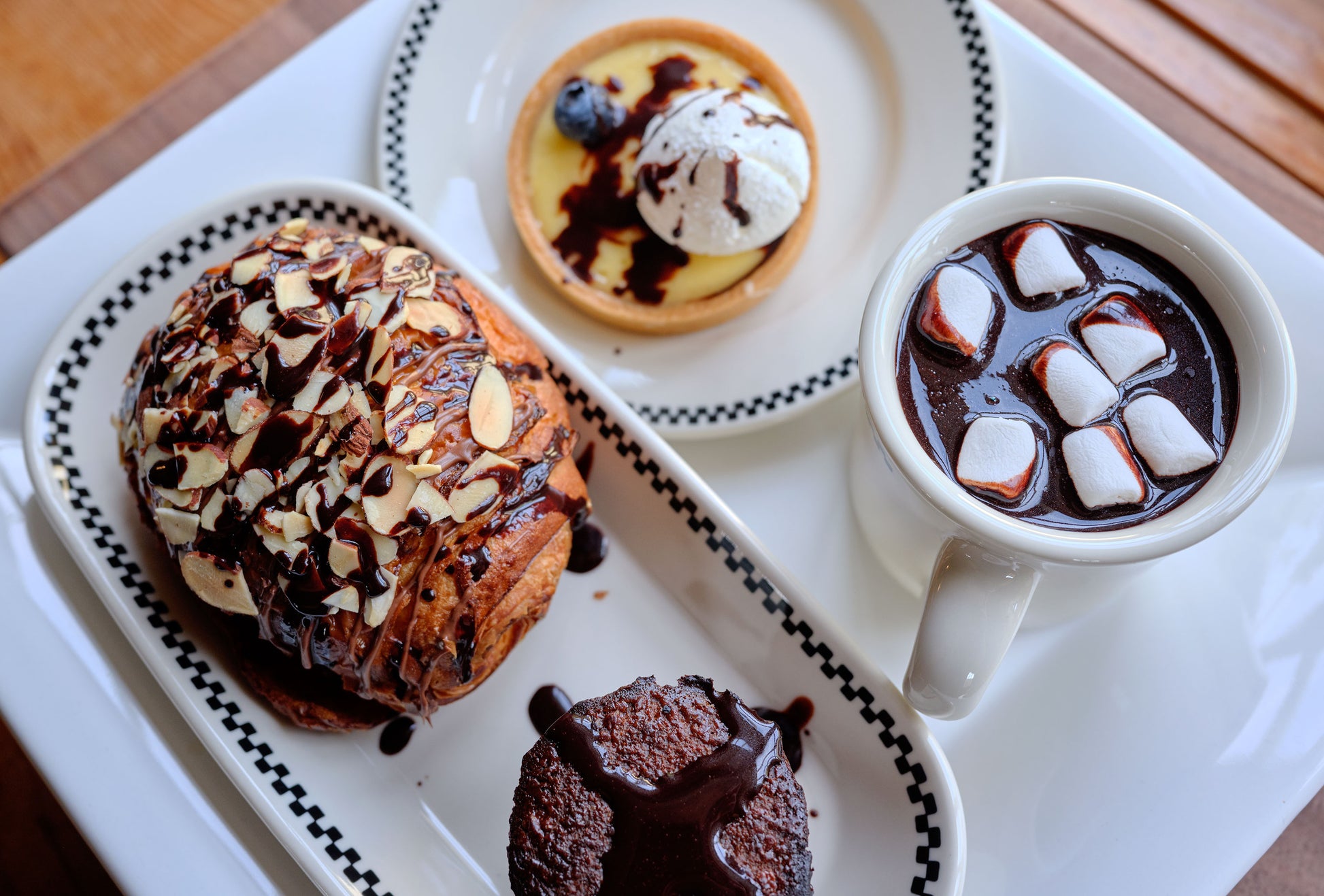 Assorted pastries and a cup of hot chocolate with marshmallows on a tray - ChefShop Grande Brut Cocoa Powder