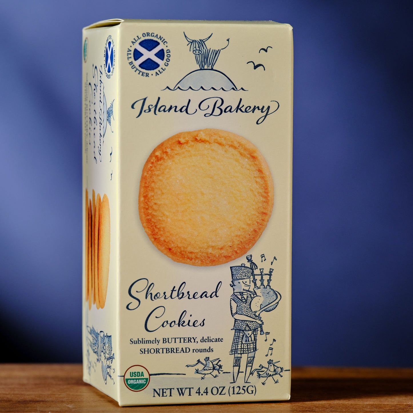 Box of Island Bakery Shortbread Cookies on a wooden surface with a blue background Island Bakery Shortbread Biscuits