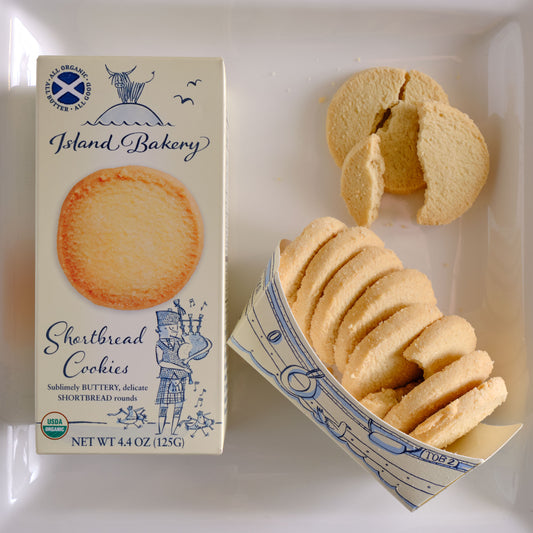 Box of Island Bakery Shortbread Cookies with cookies spilling out onto a white surface Island Bakery Shortbread Biscuits