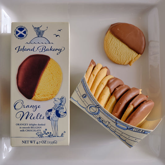 Box of Island Bakery Orange Melts with cookies on a white background