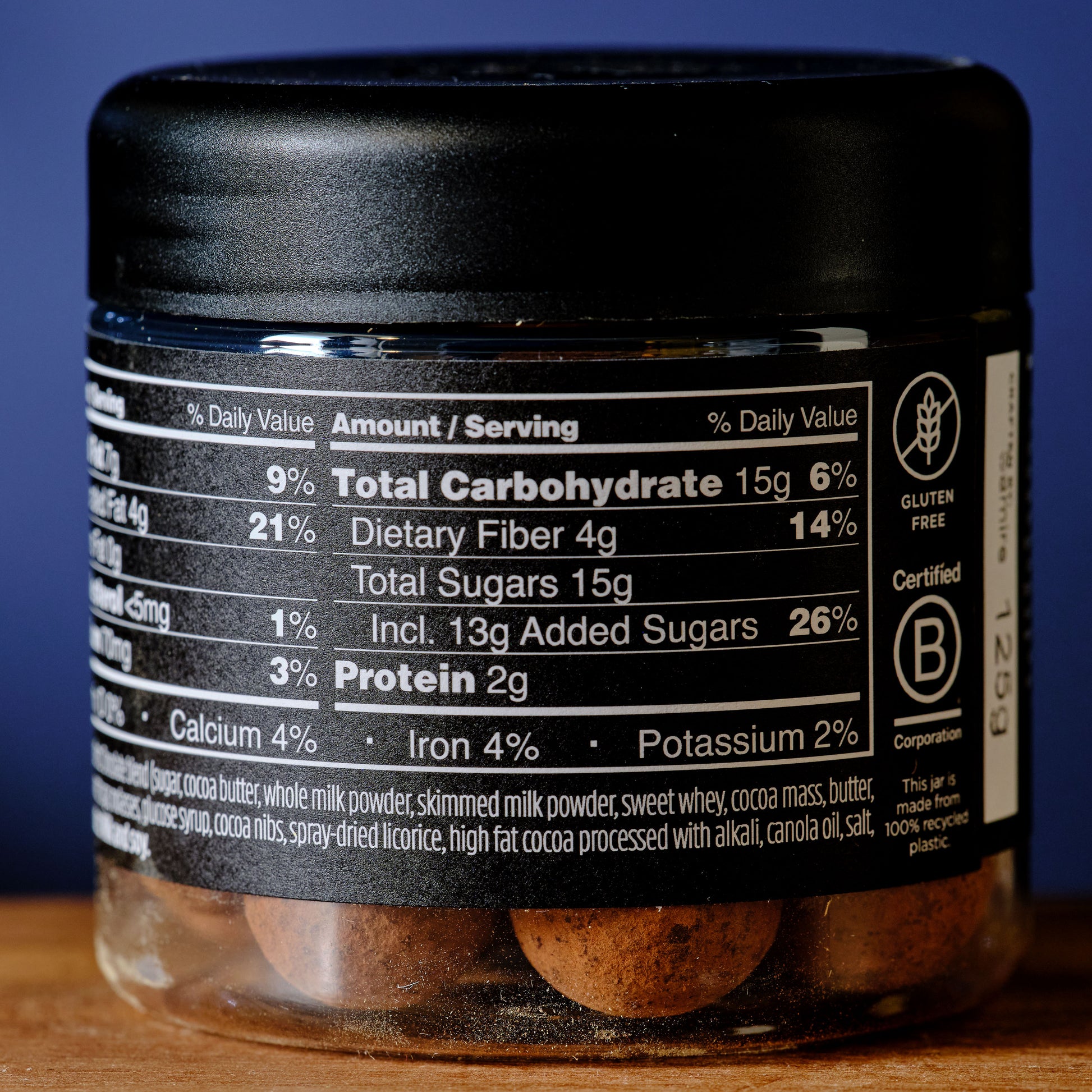 Container with nutritional label on a wooden surface and blue background