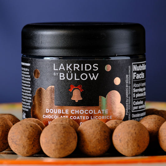 Jar of Lakrids by Bölww double chocolate licorice on a blue background