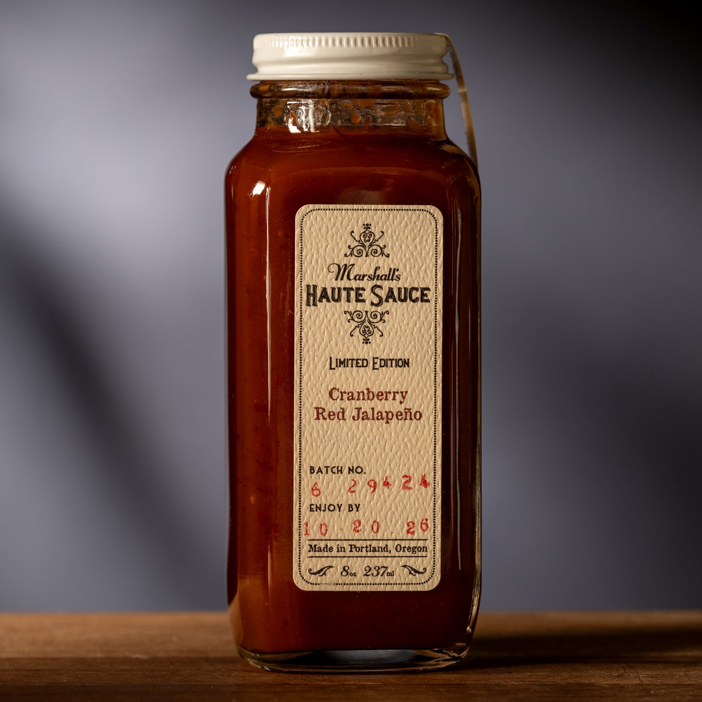 Bottle of red sauce with a label