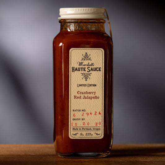 Bottle of red sauce with a label