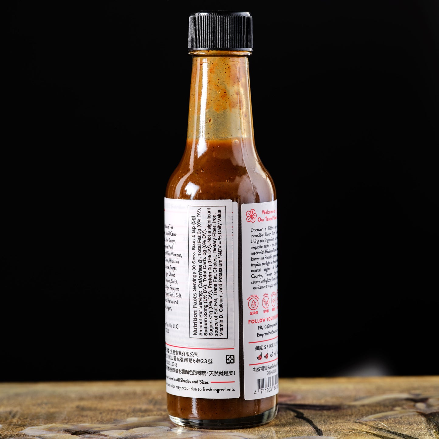 Empress Smoky Hibiscus Hot Sauce Bottle of hot sauce with label on a dark background