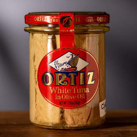 Glass jar of tuna in olive oil