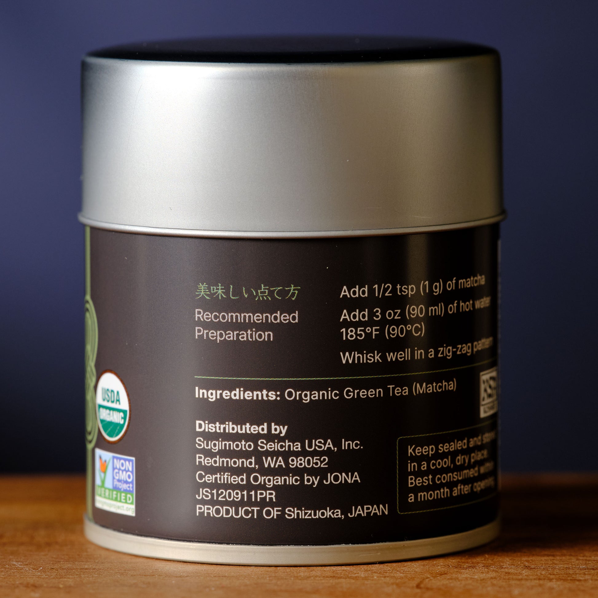 Ingredients Tea canister with label on a wooden surface and dark background