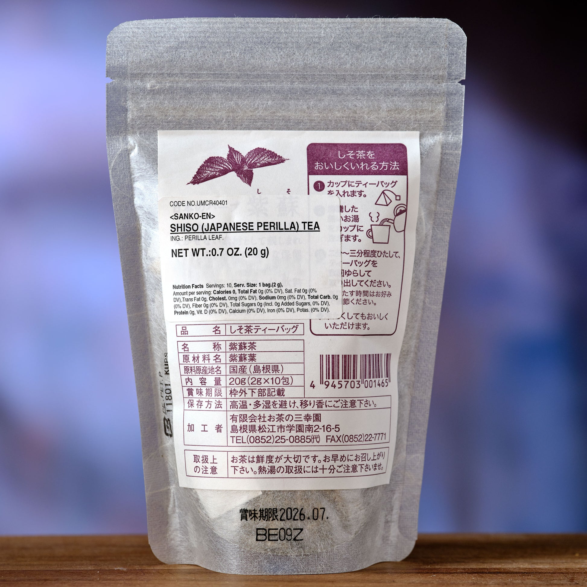 Shiso Tea - Japanese Perilla - Tea package with label on a wooden surface and blurred purple background