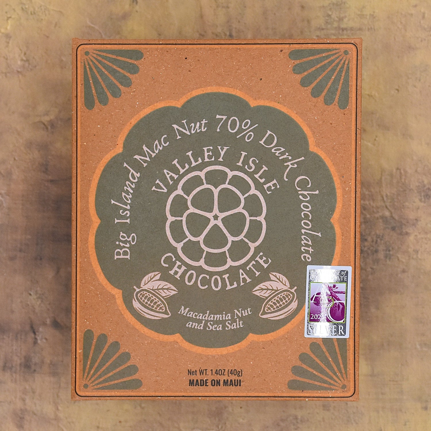 Valley Isle Chocolate packaging with macadamia nut and sea salt flavor on a wooden background